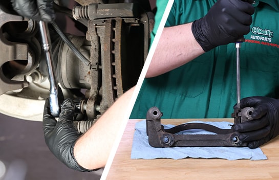 Auto parts professional removing the caliper bracket on a Ford F-150