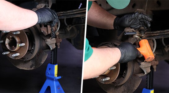 Auto parts professional installing new brake hardware on a Ford F-150 caliper bracket