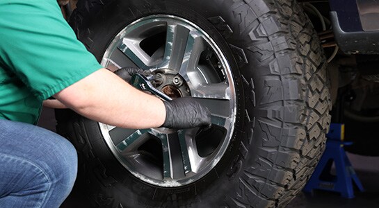 Auto parts professional torquing the lug nuts on a Ford F-150