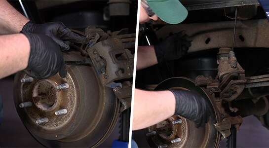 Auto parts professional detaching and hanging a Ford F-150 caliper housing