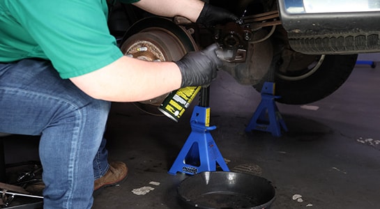 Auto Parts Professional cleaning a Ford F-150 caliper piston