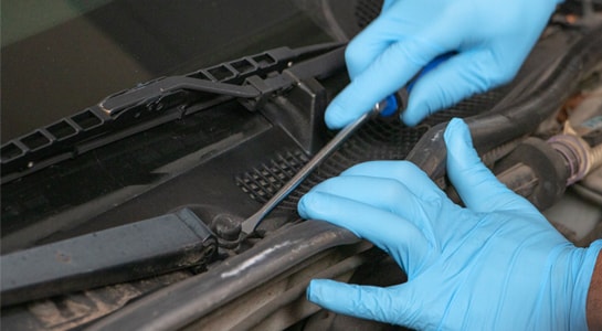 Flathead screwdriver removing plastic caps