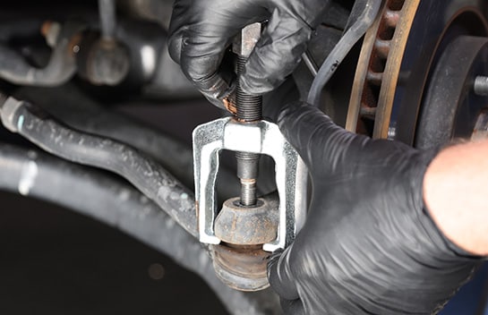 Position the legs of the puller over the pitman arm or tie rod.