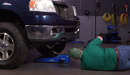 Auto parts professional preparing to change the oil in a Ford F-150
