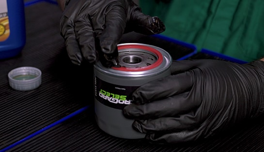 Auto parts professional prepping a new Ford F-150 oil filter