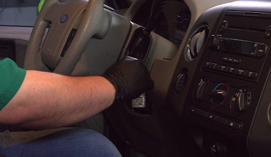 Auto parts professional turning a key in the ignition in a 2006 Ford F-150