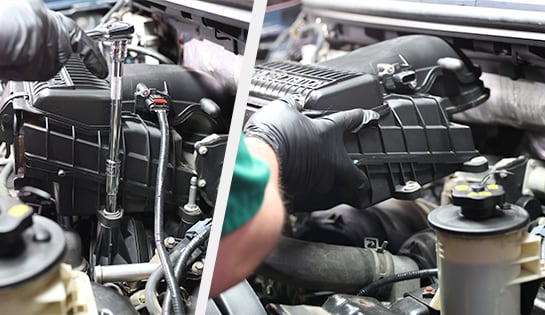 Auto parts professional removing the air intake and air filter box from a Ford F-150